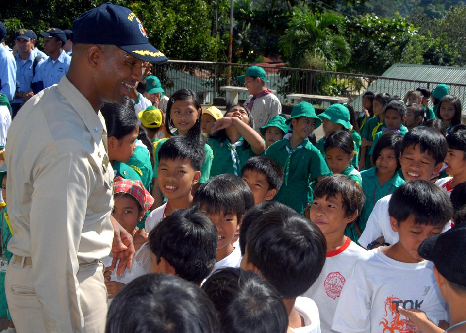 US Navy 071016-N-6710M-023 Students of Gordon Heights Elementary School greet Cmdr. Todd A. Lewis, commanding officer of the USS Tortuga (LSD 46), while conducting a community relations project in the Republic of Philippines