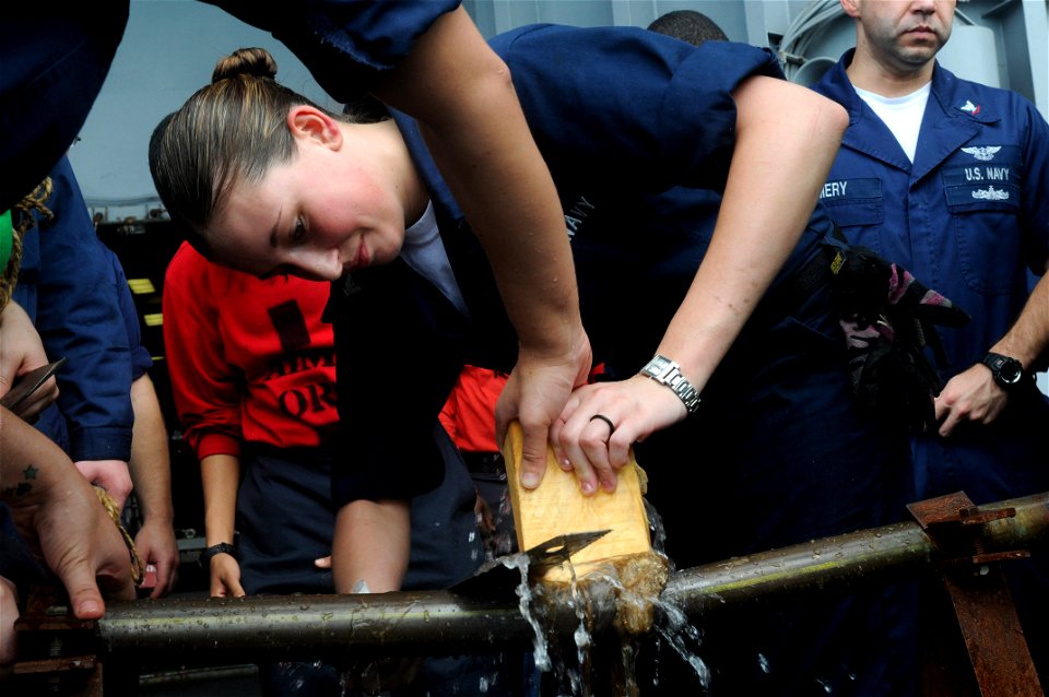 US Navy 090702-N-2344B-082 Aviation Support Equipment Technician 3rd Class Amy Jarvis cuts a wedge to patch a pipe during repair locker training aboard the aircraft carrier USS Ronald Reagan (CVN 76)