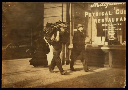 Man carrying bundle of garments. Bleeker St., N.Y. LOC nclc.04174 photo