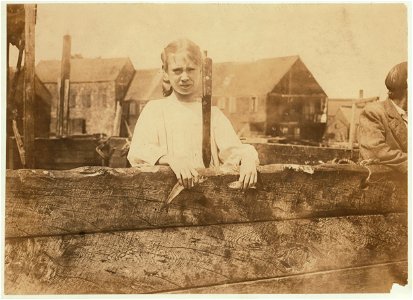 Minnie Thomas, 9 years old, showing average size of sardine knife used in cutting. Some of the children used a knife as large as this. Minnie works regularly in Seacoast Canning Co., Factory LOC nclc.05475 photo