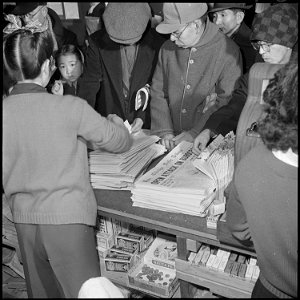 Heart Mountain Relocation Center, Heart Mountain, Wyoming. Big city newspapers on the counter of th . . . - NARA - 539200 photo