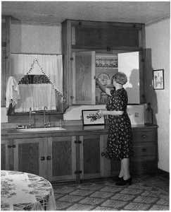Haskell County, Kansas. This lady's husband built all of the cabinets in this kitchen, which is a fi . . . - NARA - 522157 photo