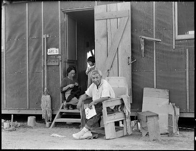 Manzanar Relocation Center, Manzanar, California. Evacuees family of Japanese ancestry relax in fro . . . - NARA - 537989 photo