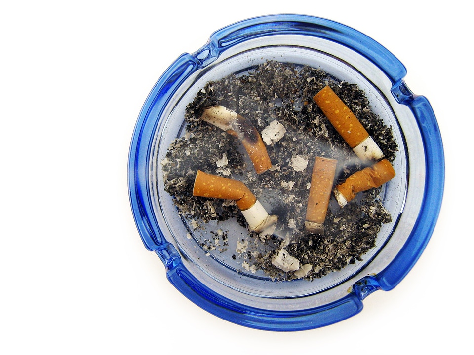 cigarettes in blue ashtray photo