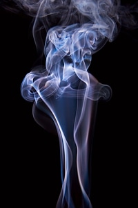 Blue swirl of smoke on black photo