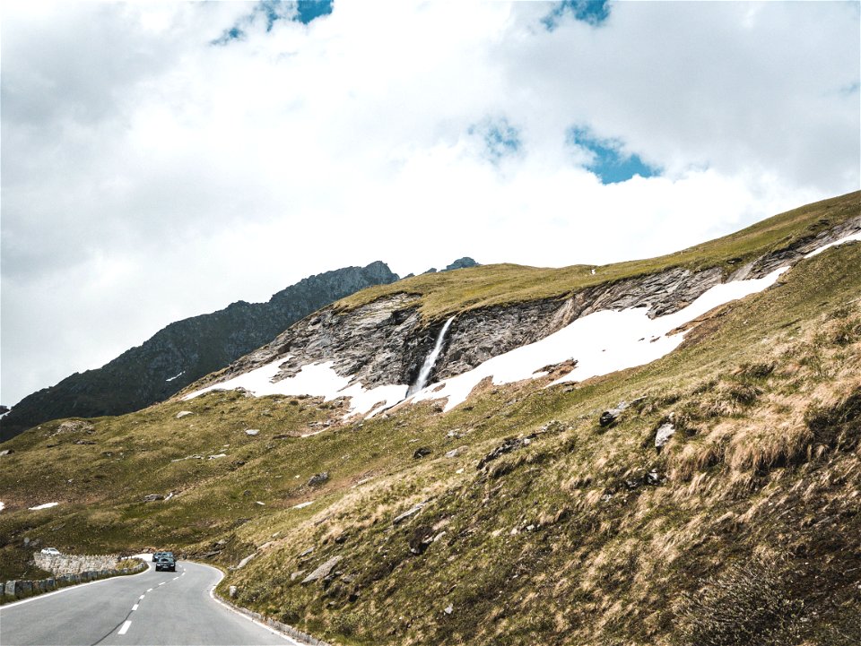 Asphalt Road Beside Green Hills At Daytime