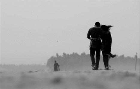 Grayscale Photography Of Couple Walking On Ground photo
