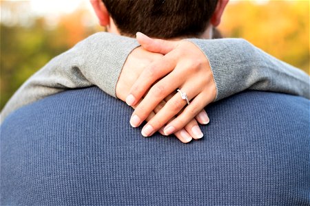 Woman Hand On Mans Neck photo