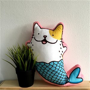 Mermaid Cat Pillow Beside Plant photo