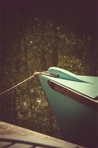 Teal Wooden Boat On Lake photo