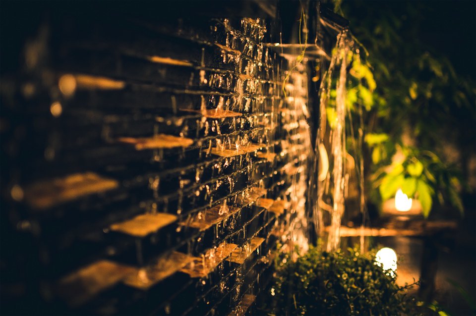 Selective Focus Photography Of Brown Brick Wall During Nighttime