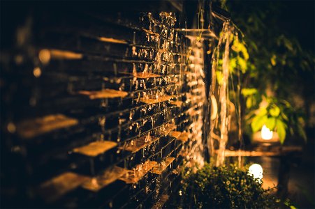 Selective Focus Photography Of Brown Brick Wall During Nighttime photo