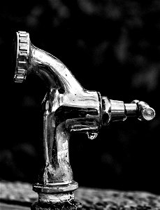Grayscale Photo Of Stainless Steel Faucet photo