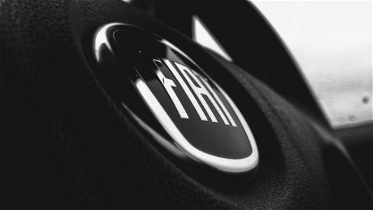 Greyscale And Closeup Photograph Of Fiat Steering Wheel photo