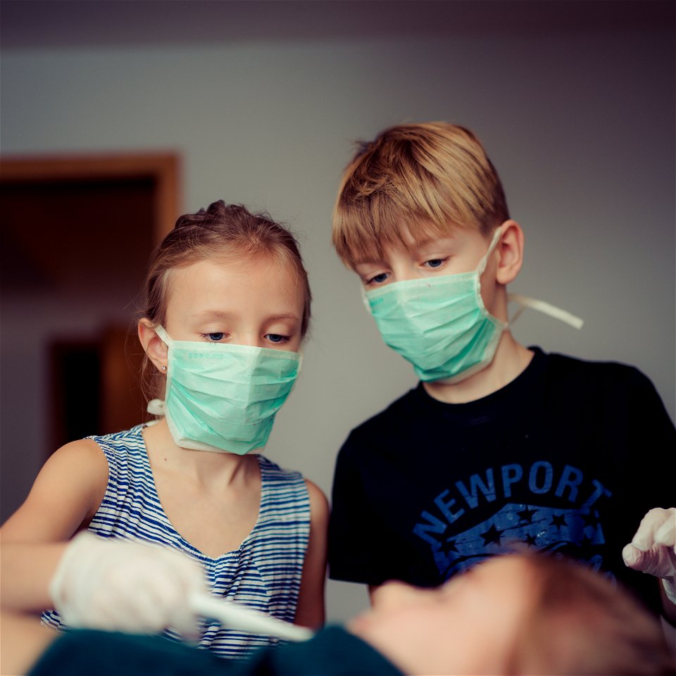 Two Children Wearing Surgical Masks photo