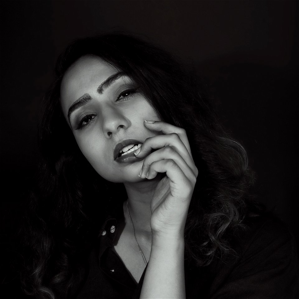 Woman In Black Top Touching Her Bottom Lip