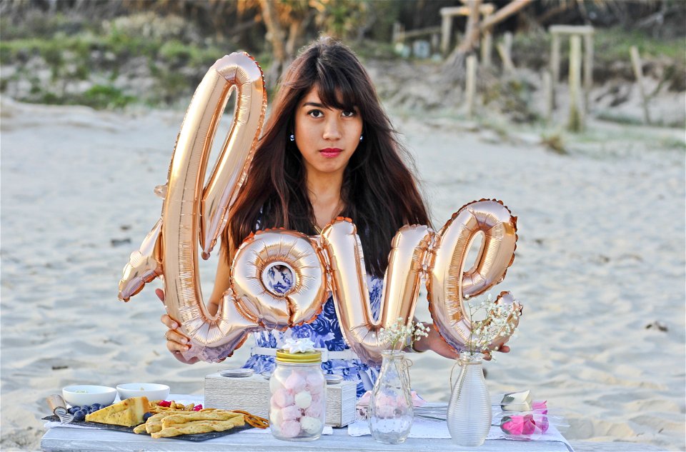 Woman Holding Gold Foil Balloons