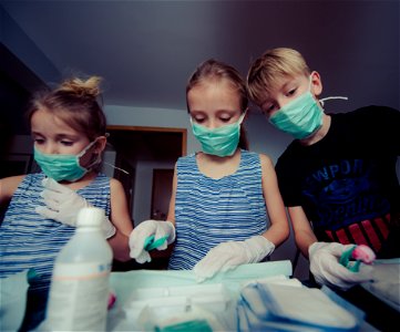 Three Children Wearing Face Masks photo