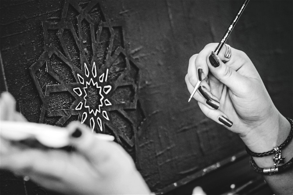 Black And White Photo Of Hands Holding A Paintbrush