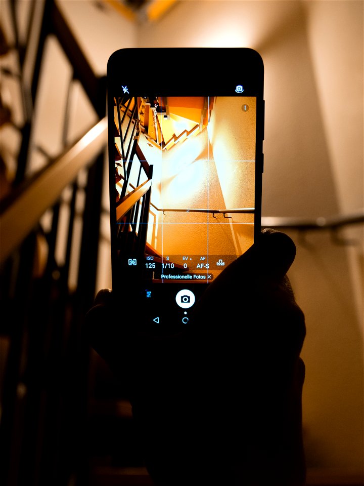 Person Holding Smartphone Showing Camera Application photo