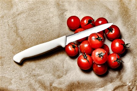 Tomatoes With Knife On Brown Surface photo