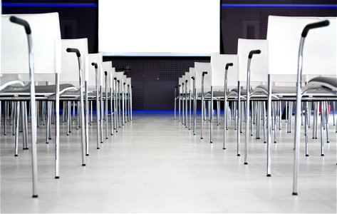 Low Angle Photography Of Pile Of Stainless Steel Chairs With Hanging Projector Canvas photo
