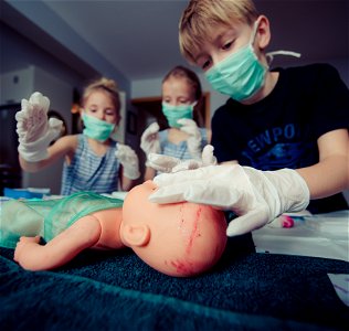 Three Children Playing Operation Toy
