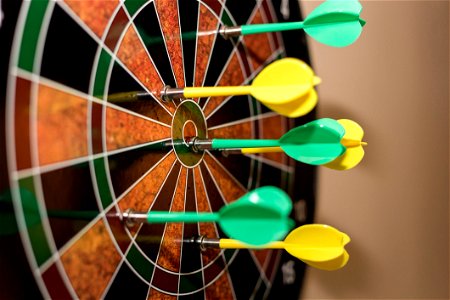 Green And Yellow Darts On Brown-black-green-and-red Dartboard