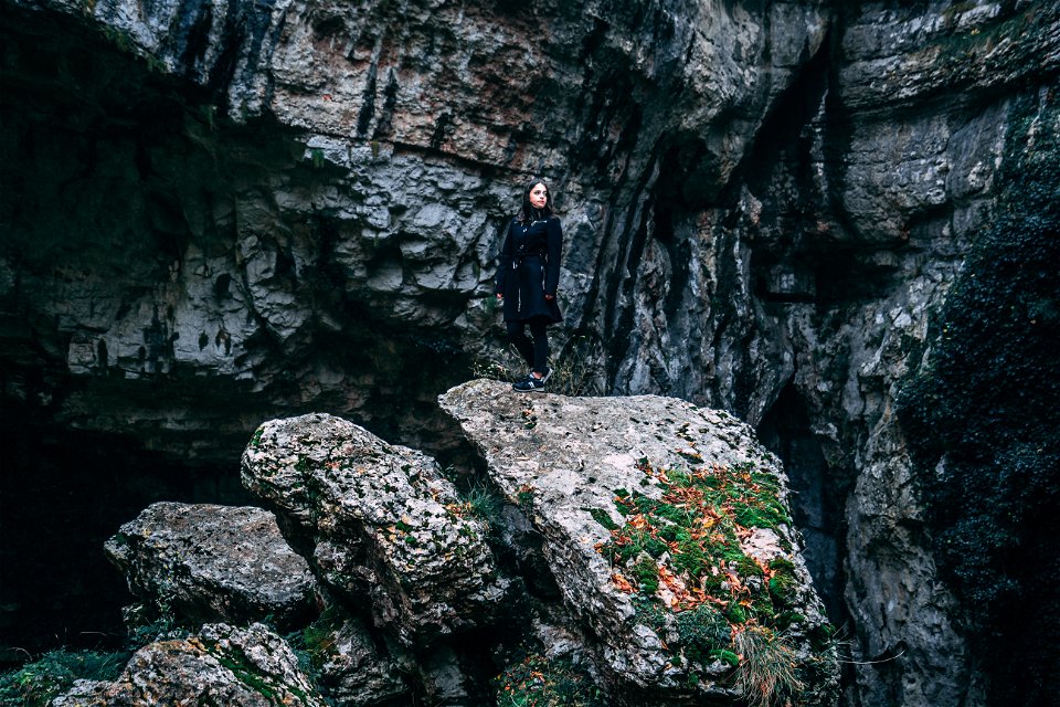Photo Of Woman In Black Outfit Standing On Rock photo