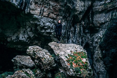 Photo Of Woman In Black Outfit Standing On Rock