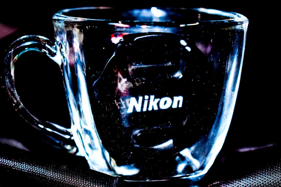 Close Up Photo Of Clear Glass Mug With Nikon Lens Cap photo