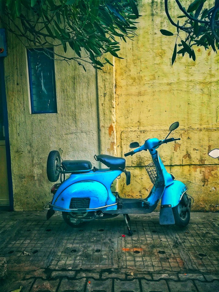 Teal Motor Scooter On Road photo