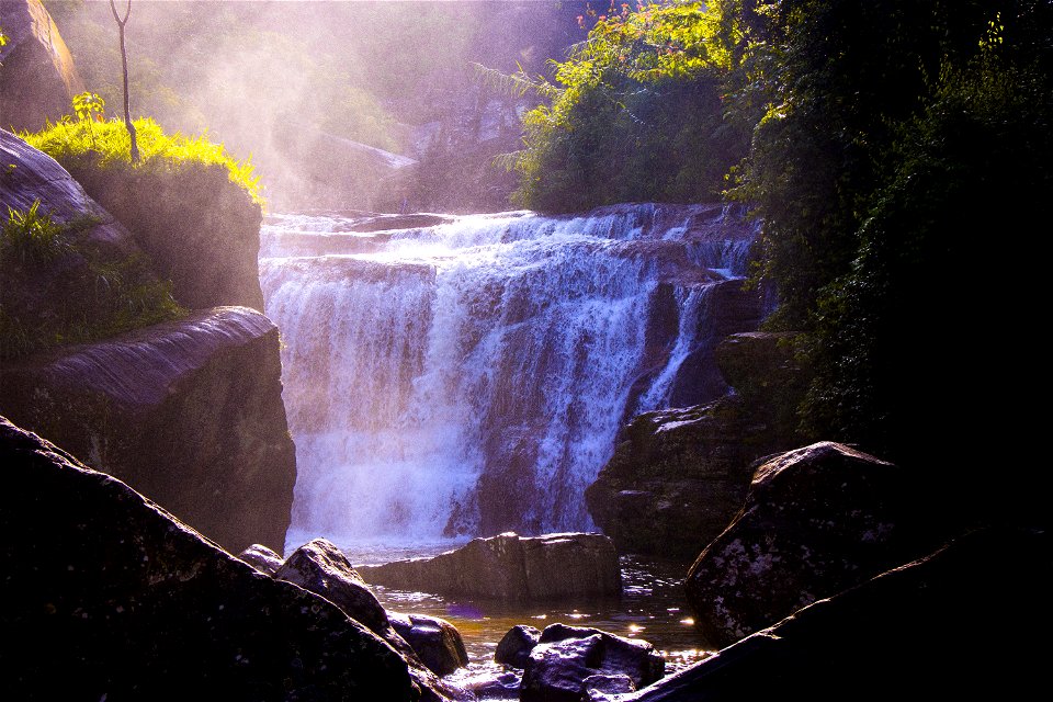 Waterfalls Surrounded By Grass And Rocks