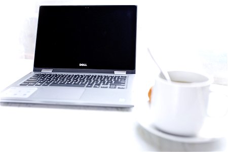 Dell Laptop In Front Of Cup Of Coffee photo