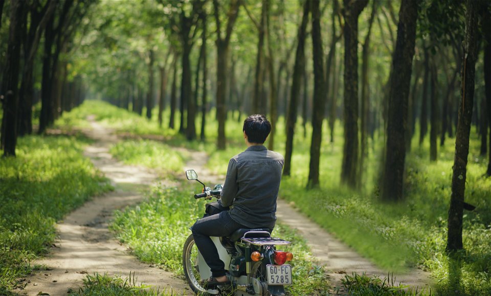 Man Riding A Moped photo