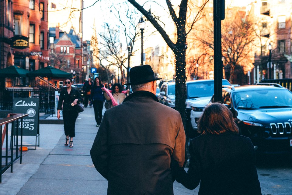 Man In Black Hat Holding His Wife
