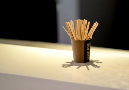 Brown Popsicle Sticks In Brown Disposable Cup photo