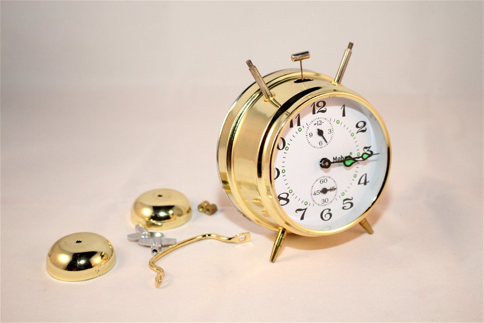 Round Brass And White Bell Alarm Clock photo