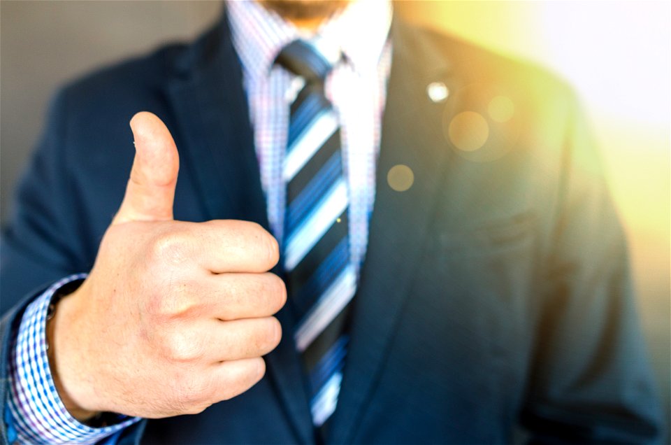 Close-up Photo Of Man Wearing Black Suit Jacket Doing Thumbs Up Gesture photo
