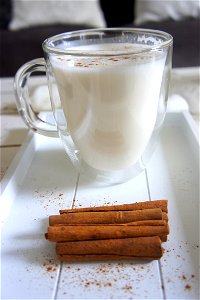 Cinnamon Sticks Beside The Glass Of Milk photo