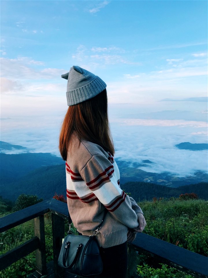 Standing Woman Wearing White And Gray Sweater