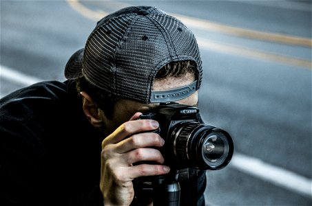 Man Taking Photo Using Black Canon DSLR Camera photo