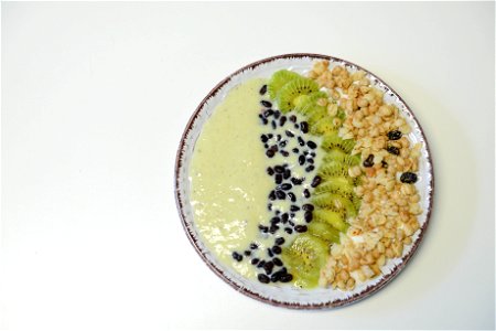 Slice Kiwifruit And Nuts On Plate photo