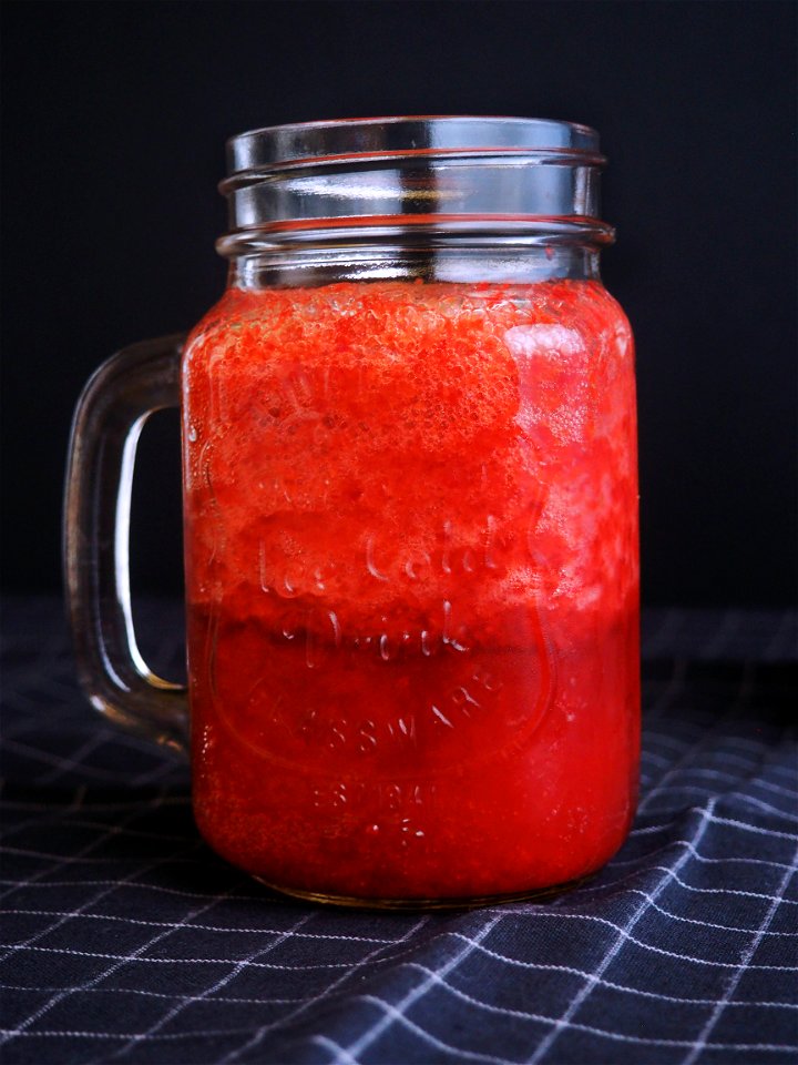 Clear Glass Mason Mug Filled With Red Liquid photo