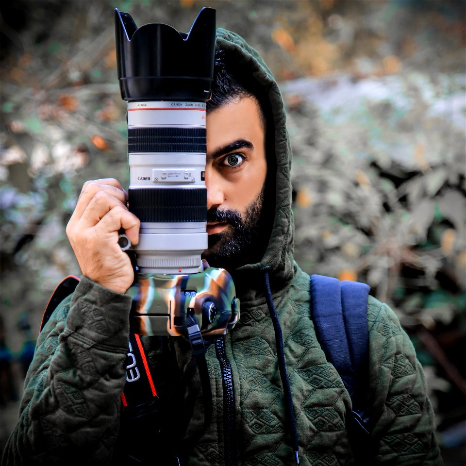 Person Holding A Dslr Camera photo