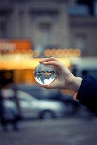 Person Holding Round Glass Ball Macro Shot photo