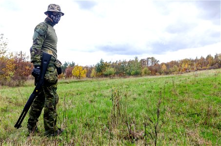 Photo Of Man Wearing Green Combat Uniform Holding Rifle photo