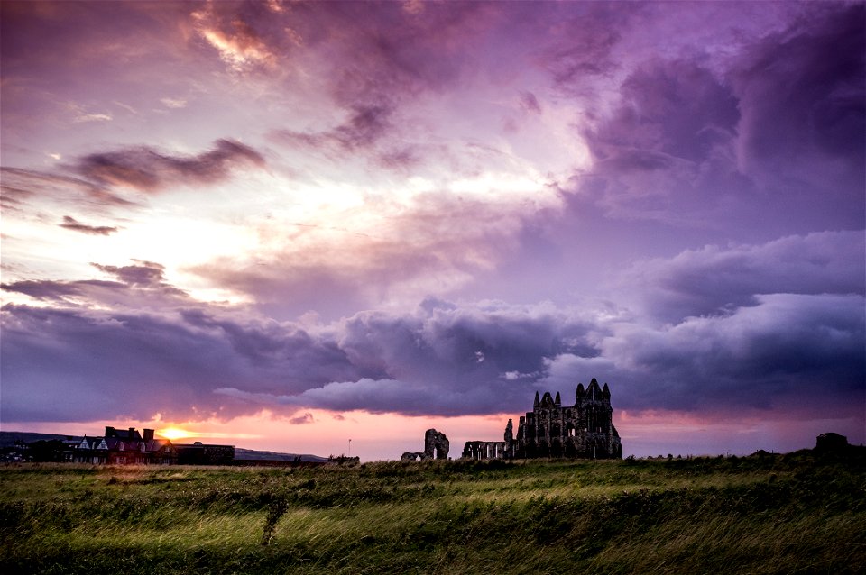 Green Field And White And Black Concrete Structure During Sunset photo