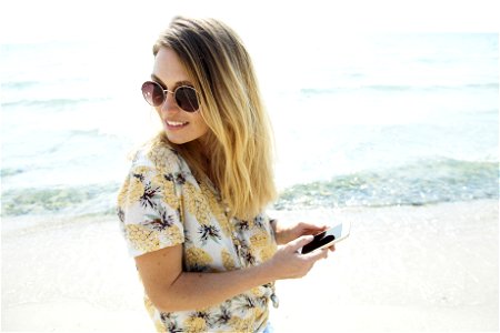 Woman Wearing Sunglasses At The Beach photo