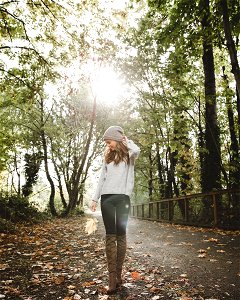 Woman In Gray Sweater Standing Between Forest Trees photo